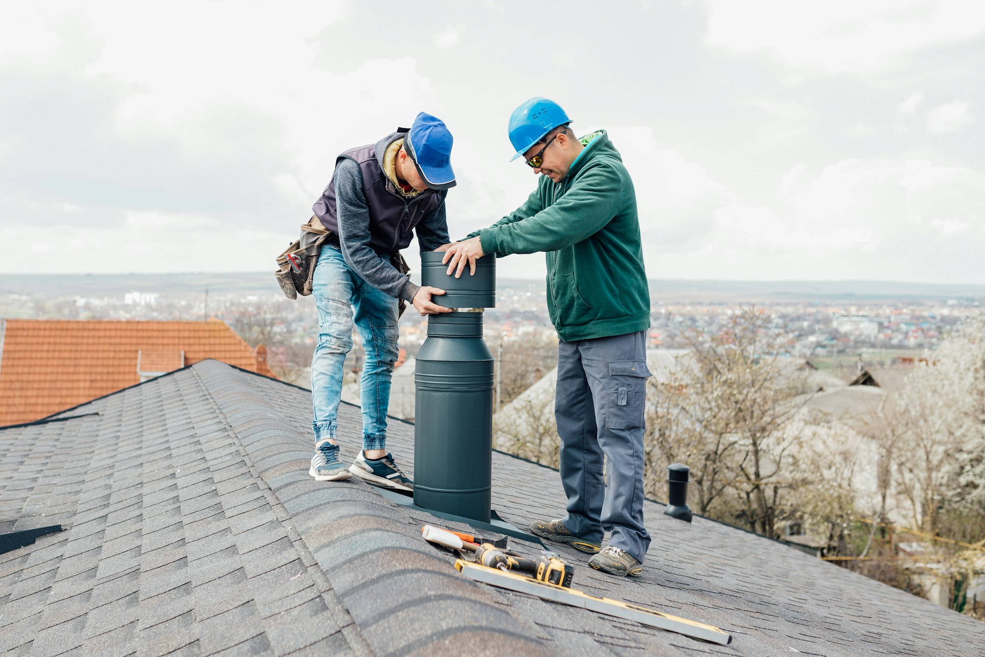 two professional masters Roofer construction workers repairing chimney